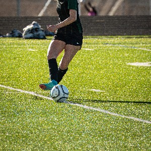 Soccer player taps the ball